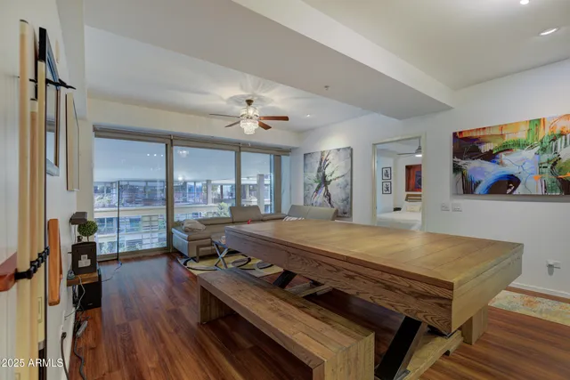 a living room with hard wood floors and a table