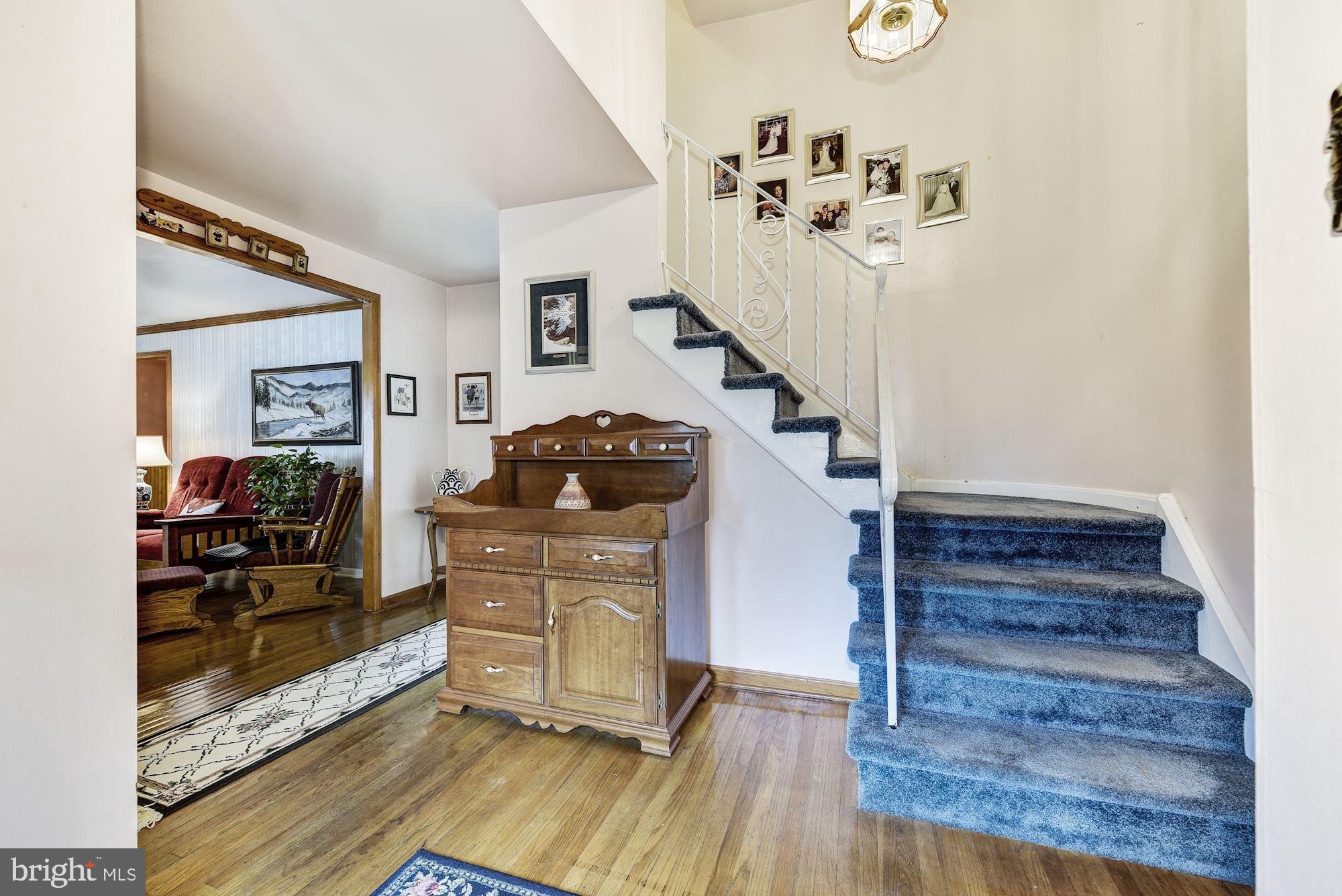 207 Regency Road Edgewater Park, NJ 08010 - Photo 13 of 36 a living room with wooden floor furniture and a chandelier