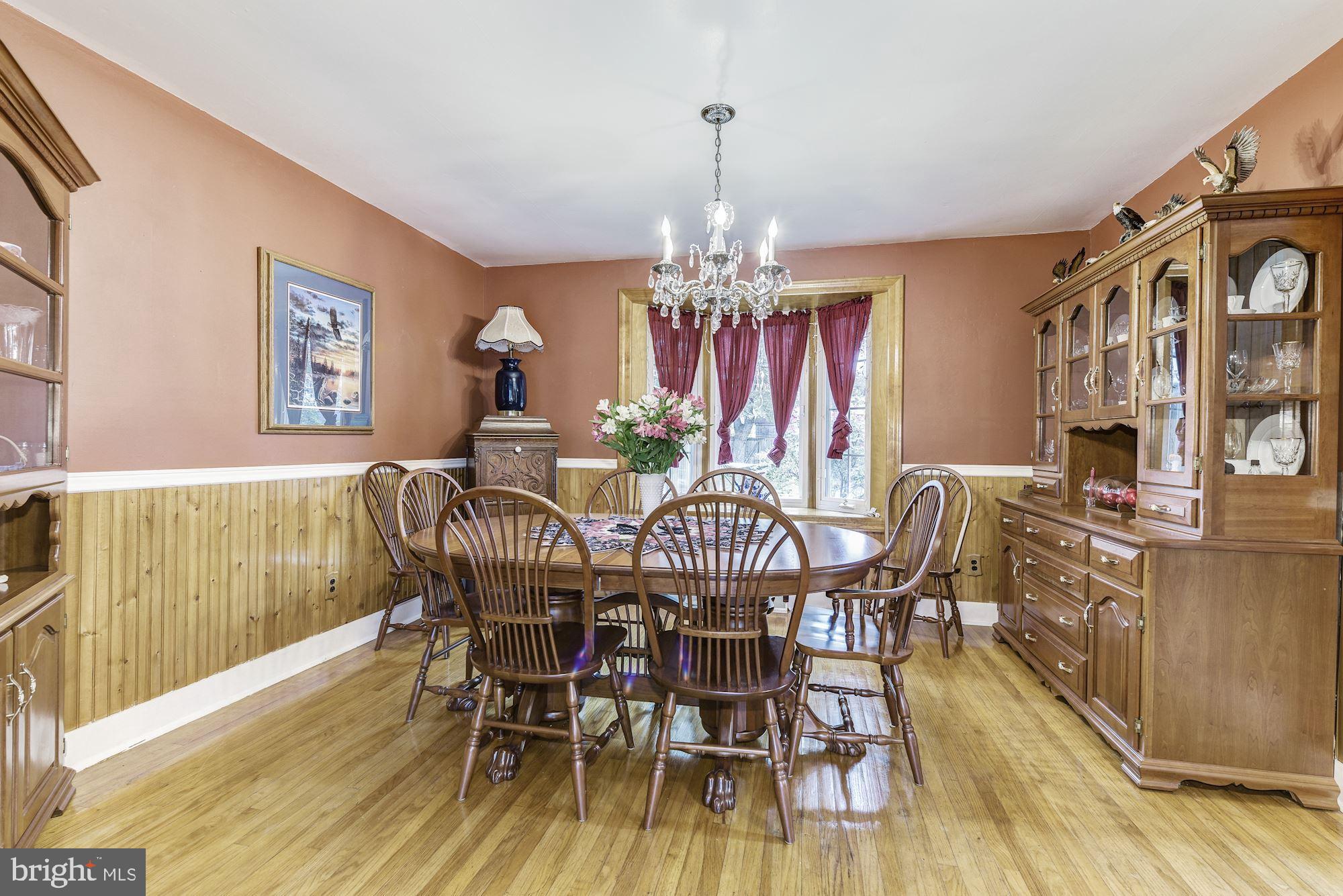 207 Regency Road Edgewater Park, NJ 08010 - Photo 17 of 36 a view of a dining room with furniture a chandelier and wooden floor