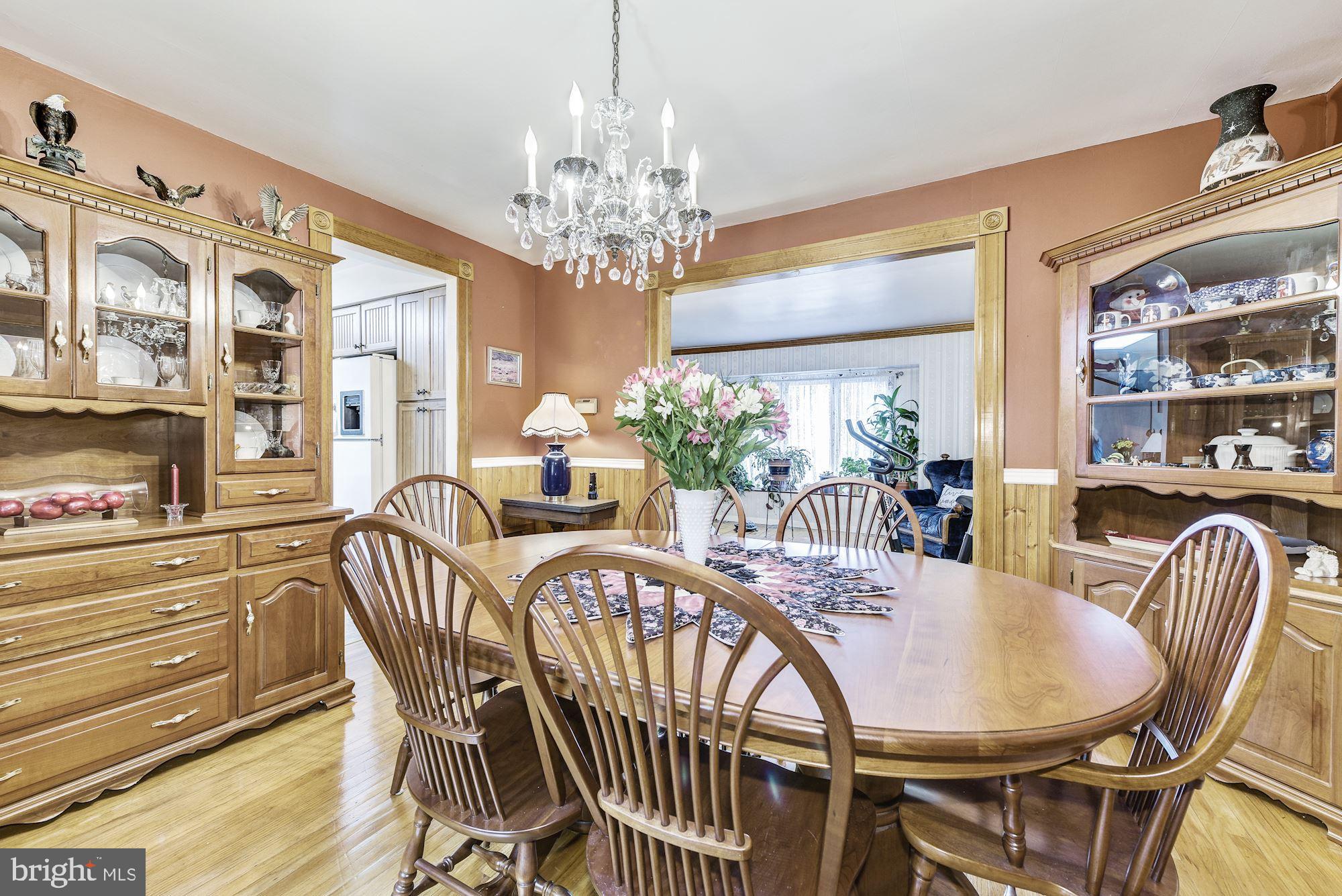 207 Regency Road Edgewater Park, NJ 08010 - Photo 18 of 36 a view of a dining room with furniture a chandelier and wooden floor