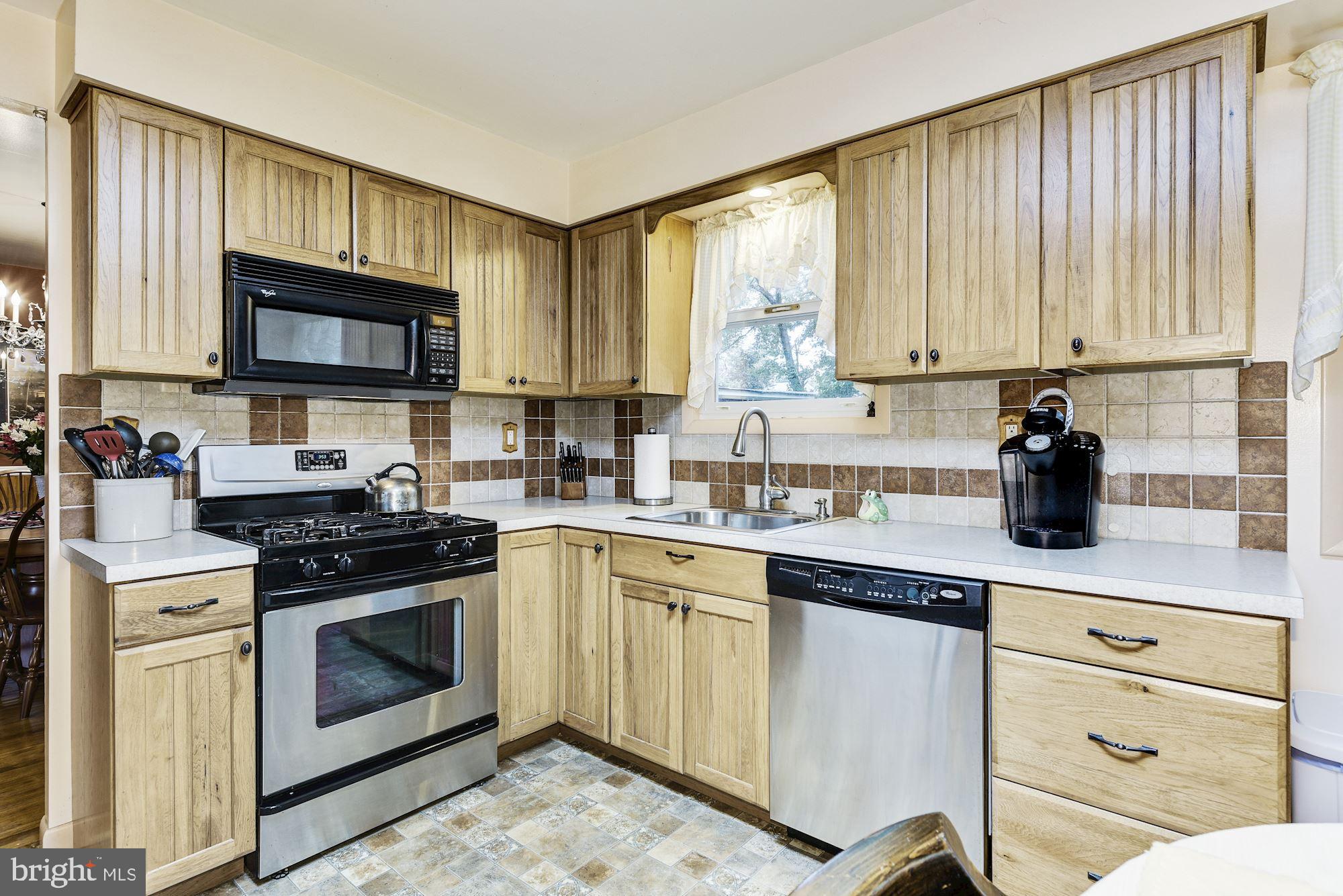 207 Regency Road Edgewater Park, NJ 08010 - Photo 19 of 36 a kitchen with a stove a sink and a microwave