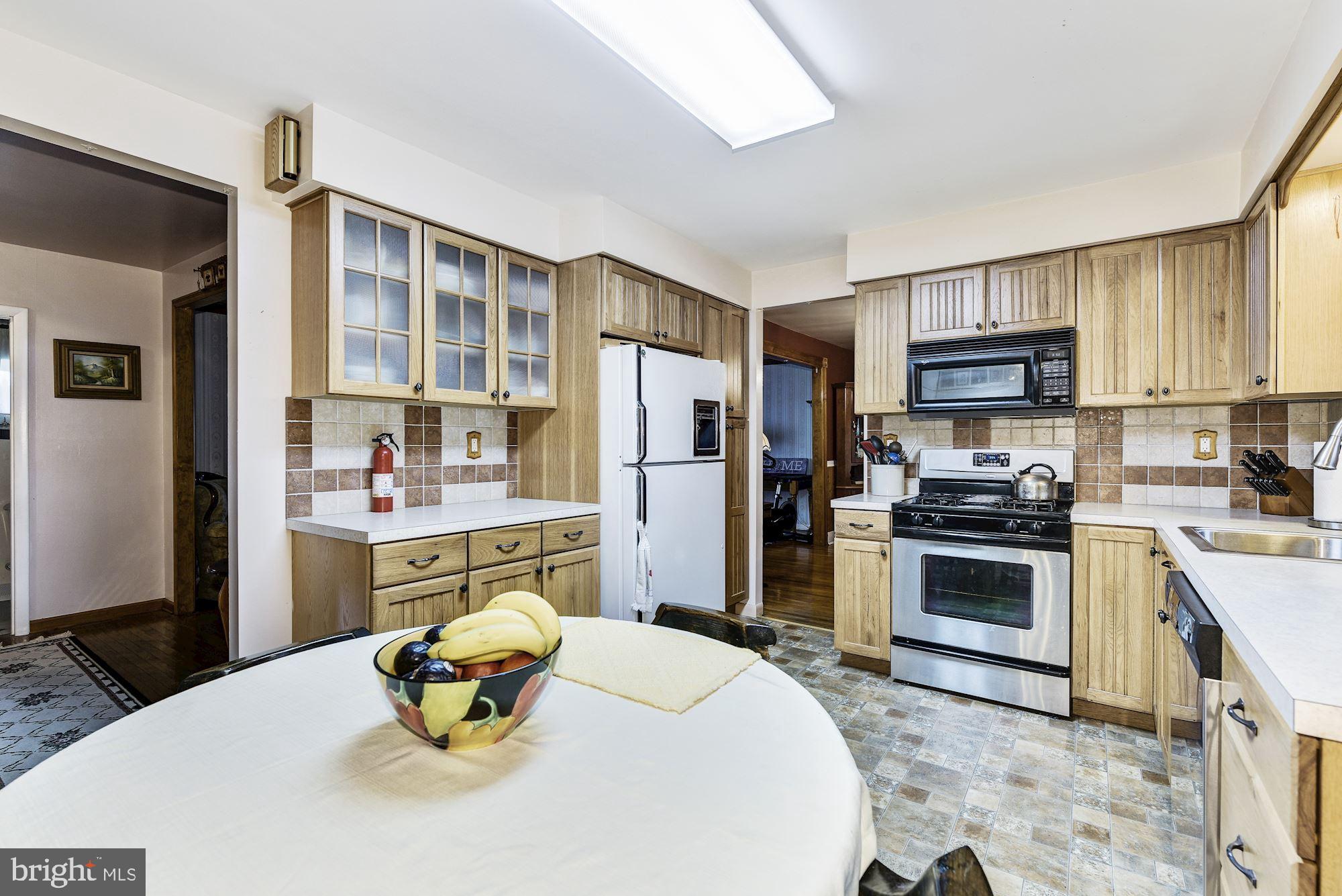 207 Regency Road Edgewater Park, NJ 08010 - Photo 22 of 36 a kitchen with stainless steel appliances granite countertop a refrigerator a stove top oven a sink and cabinets