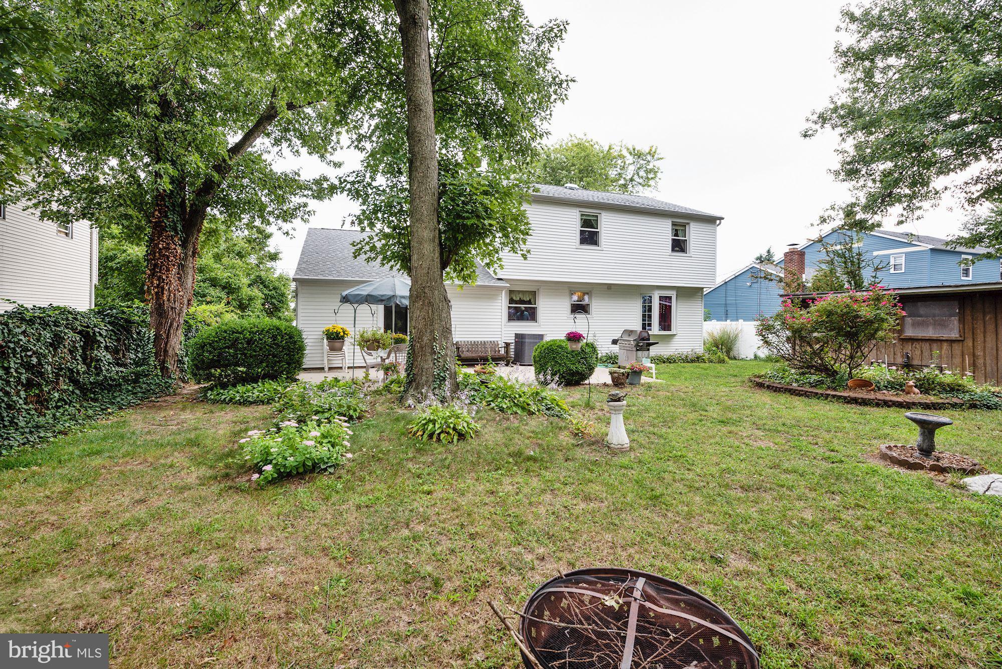 207 Regency Road Edgewater Park, NJ 08010 - Photo 5 of 36 a backyard of a house with garden and plants