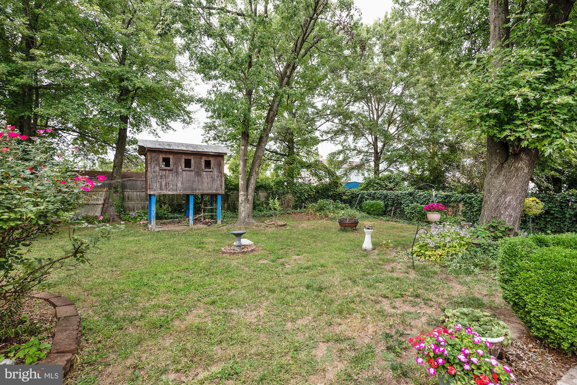207 Regency Road Edgewater Park, NJ 08010 - Photo 7 of 36 a backyard of a house with lots of green space and fountain