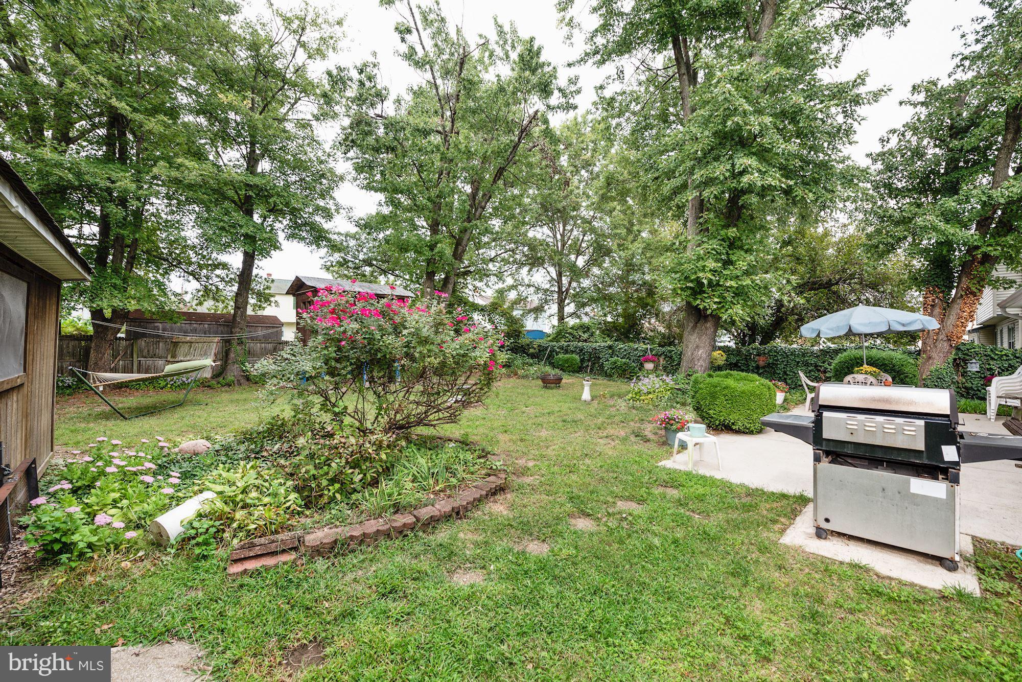 207 Regency Road Edgewater Park, NJ 08010 - Photo 9 of 36 a backyard of a house with a table and chairs