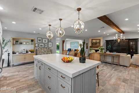 a large kitchen with counter space and living room view