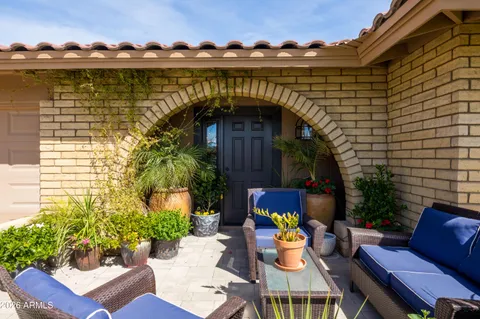 a view of a chairs with a table in the patio