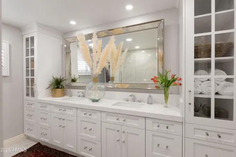 a bathroom with a double vanity sink and a mirror