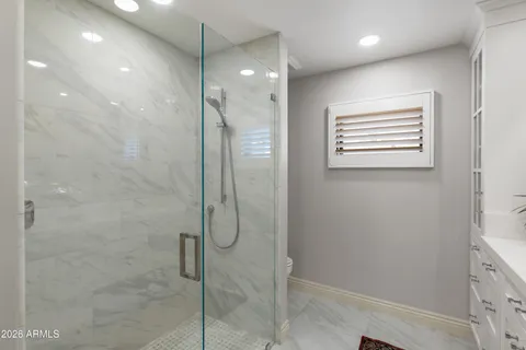 a bathroom with a shower and a shower