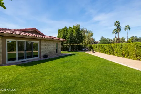 a view of a house with a backyard