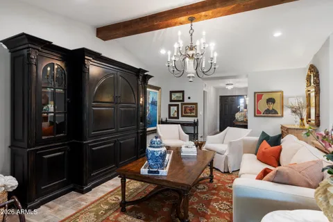 a living room with furniture and a chandelier