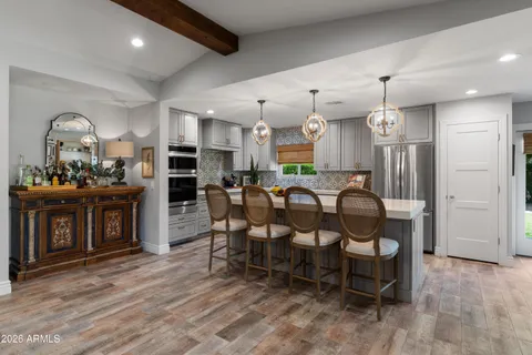 a large kitchen with a table and chairs