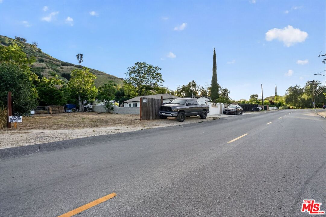 0 Castaic Road Castaic, CA 91384 - Photo 16 of 34 a car driving down a road next to a building