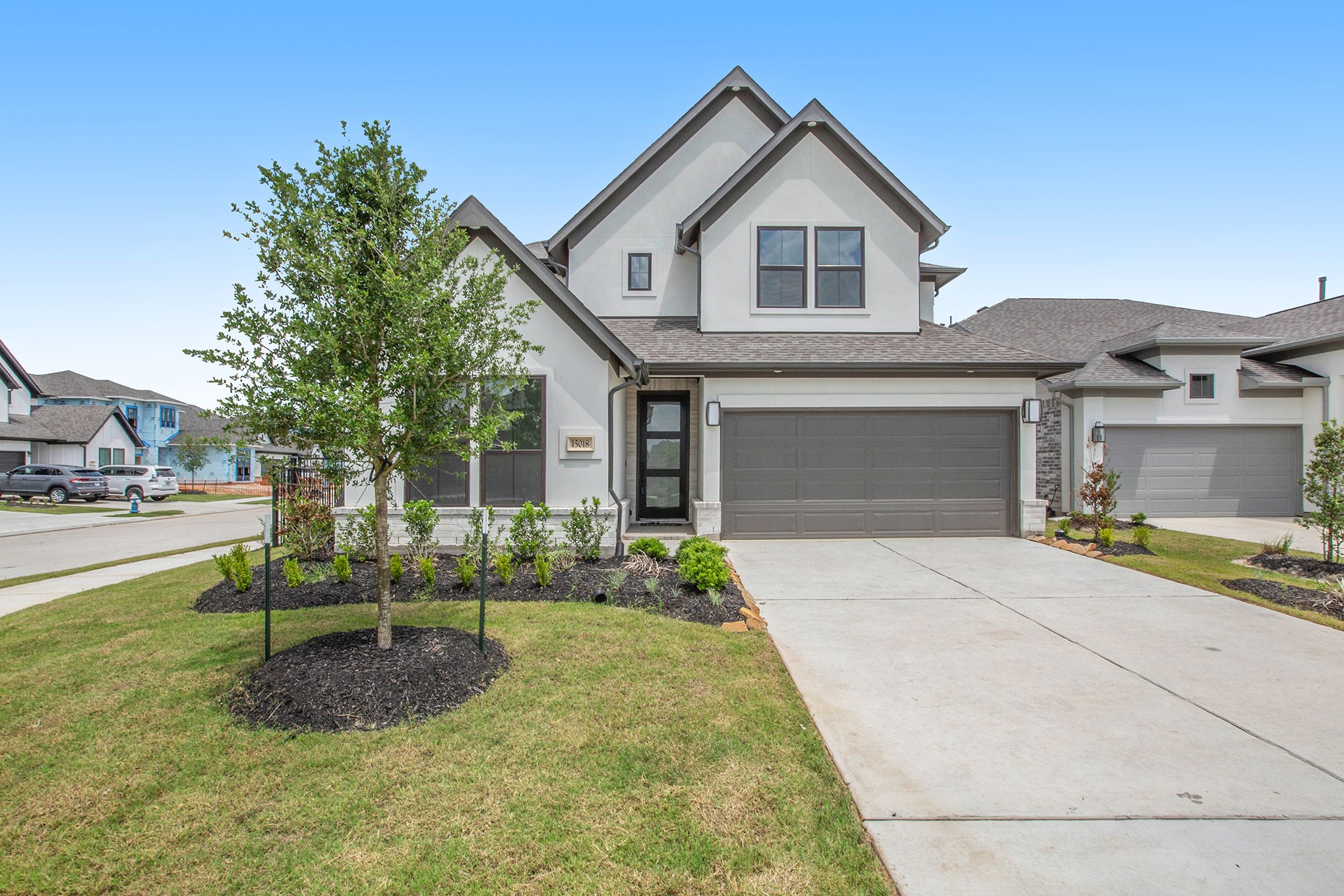 15018 Bonham Shore Drive Cypress, TX 77433 - Photo 1 of 31 a front view of a house with a yard and potted plants