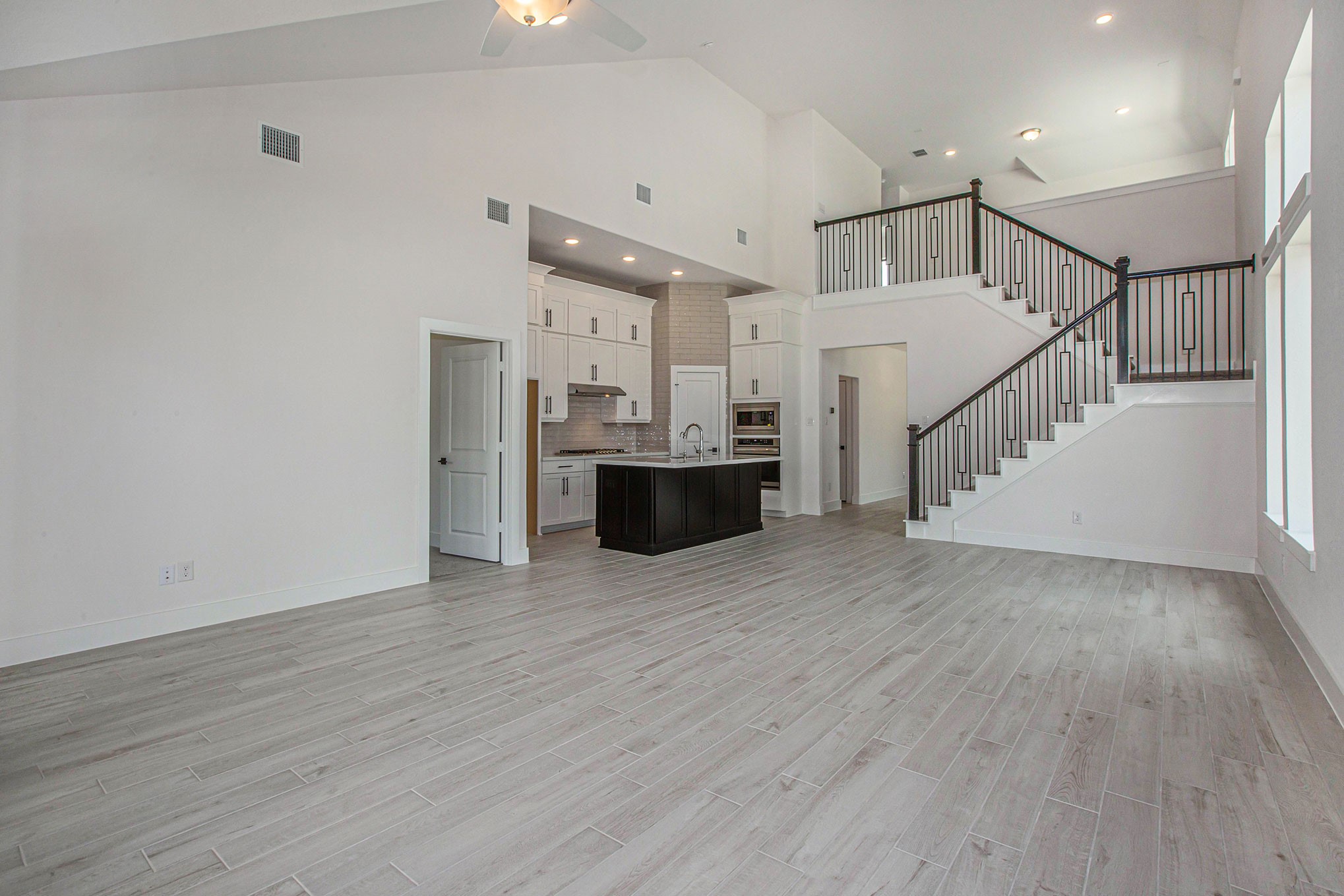 15018 Bonham Shore Drive Cypress, TX 77433 - Photo 14 of 31 a view of a room with wooden floor and staircase