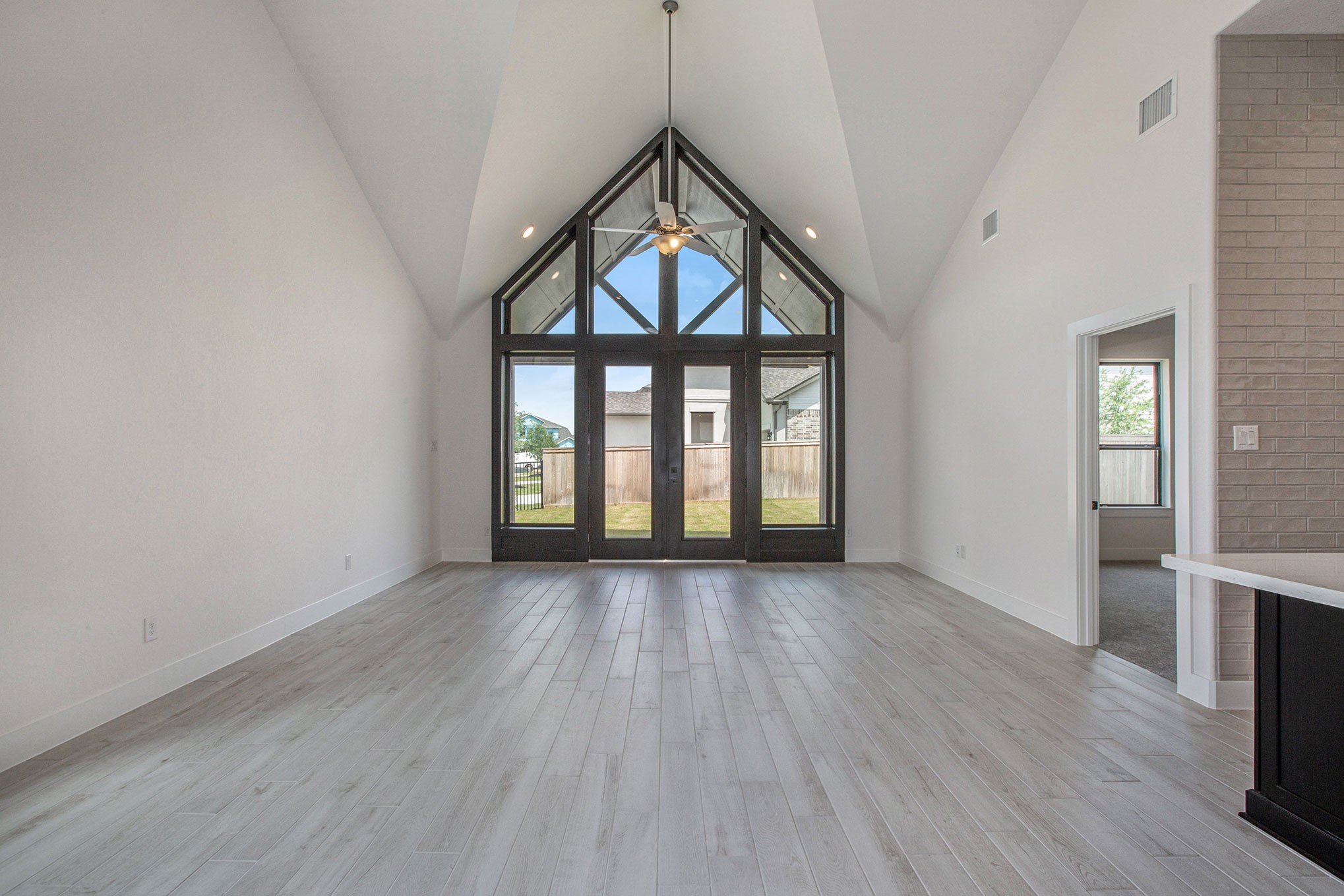 15018 Bonham Shore Drive Cypress, TX 77433 - Photo 16 of 31 wooden floor in an empty room with a window