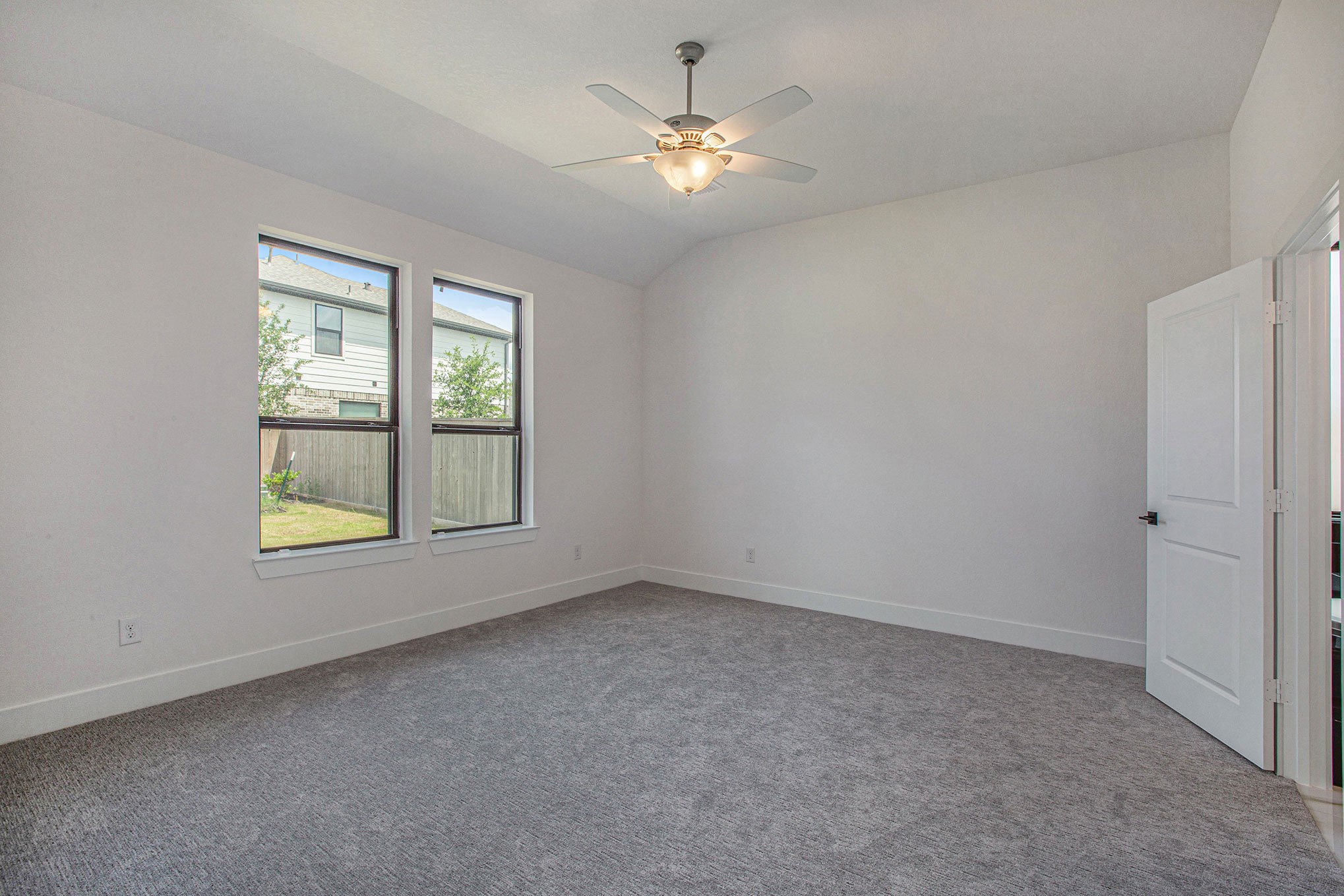 15018 Bonham Shore Drive Cypress, TX 77433 - Photo 17 of 31 an empty room with windows and fan