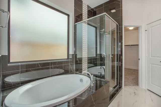 a bathroom with a tub and shower