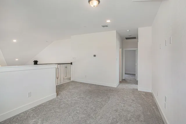 an empty room with a empty space and windows