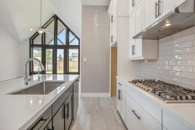 a kitchen that has a sink and a stove