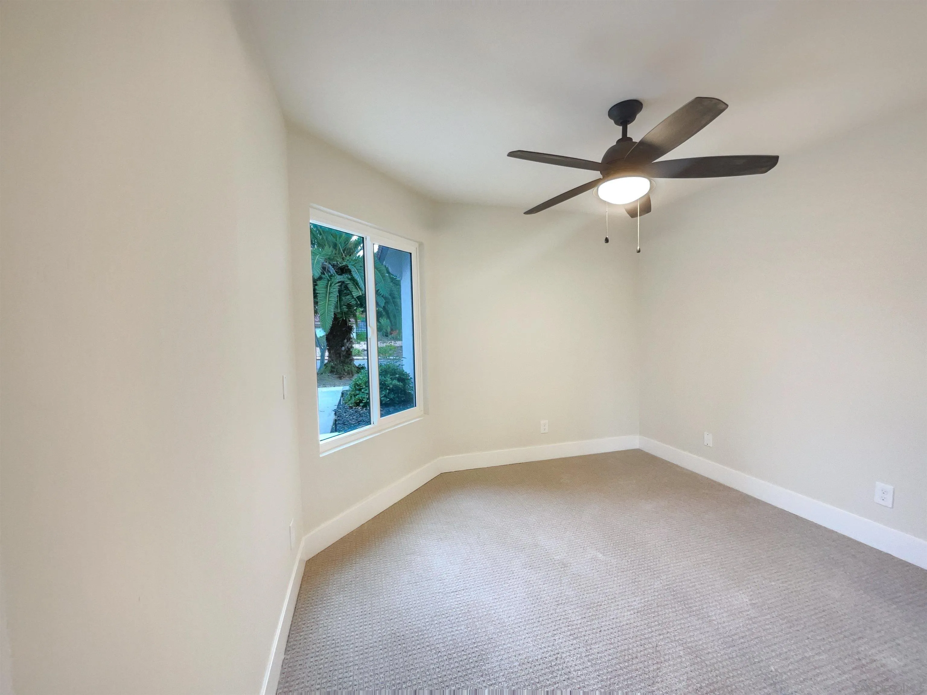 350 Whispering Brook Drive Vista, CA 92083 - Photo 12 of 17 an empty room with a window and a fan