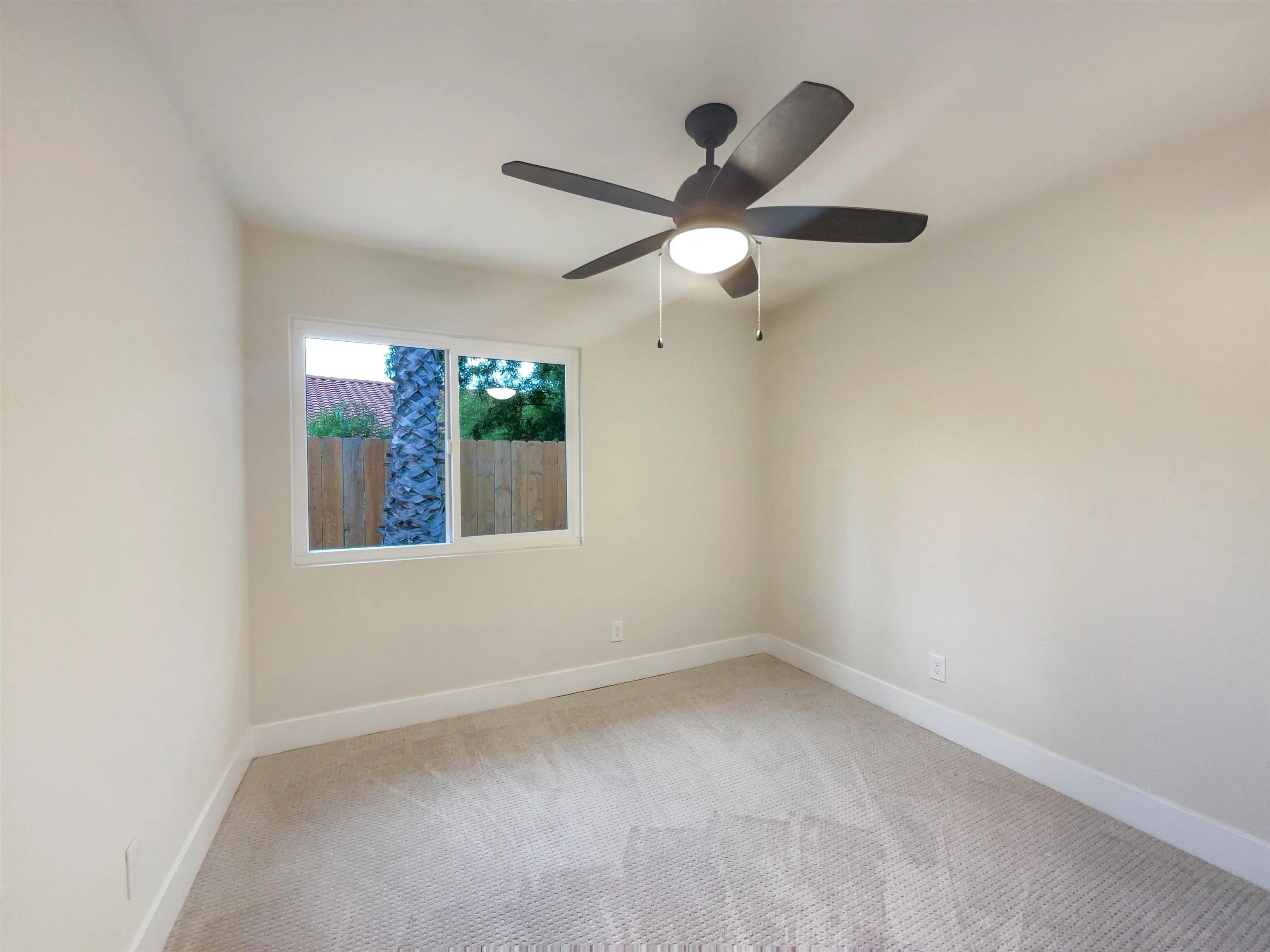 350 Whispering Brook Drive Vista, CA 92083 - Photo 13 of 17 an empty room with a window and a fan