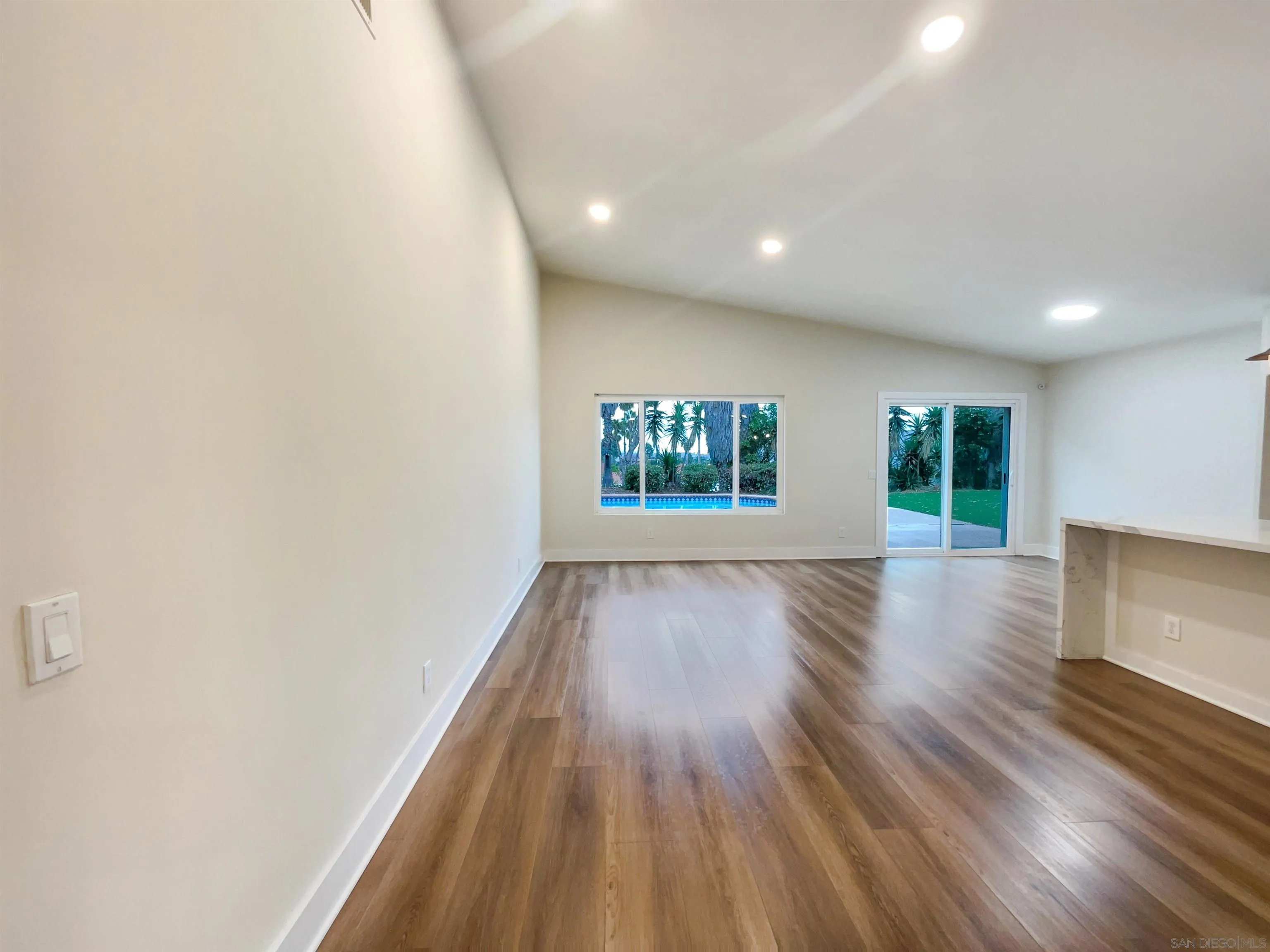 350 Whispering Brook Drive Vista, CA 92083 - Photo 8 of 17 an empty room with wooden floor and windows