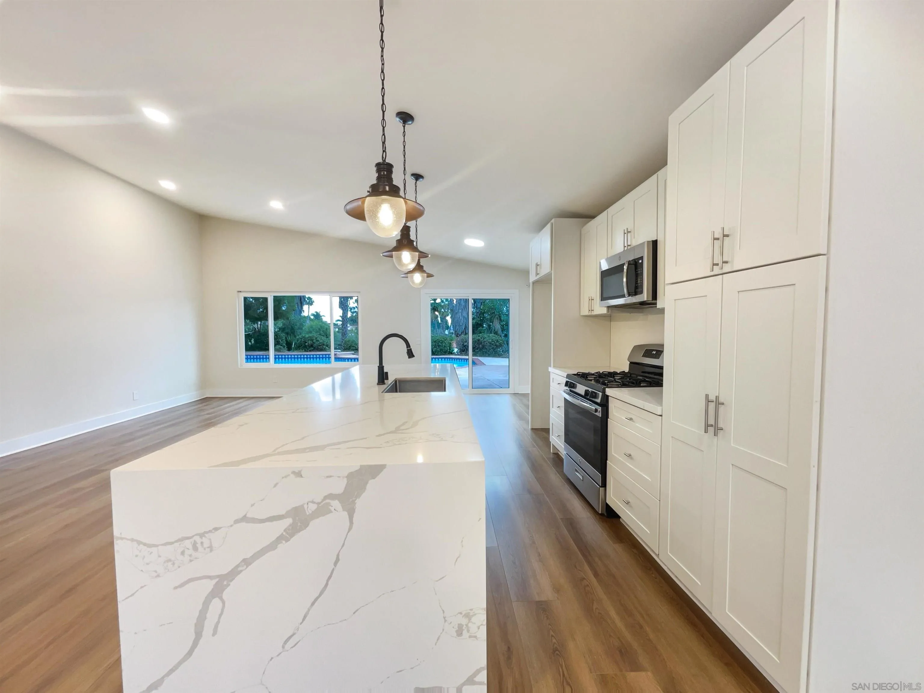 350 Whispering Brook Drive Vista, CA 92083 - Photo 9 of 17 a large kitchen with kitchen island a large counter space a sink appliances and cabinets