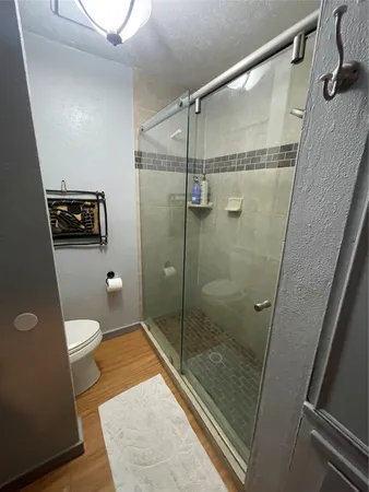 a bedroom with a bed and a mirror on the wall