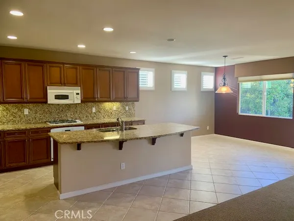a kitchen with stainless steel appliances granite countertop a sink counter space cabinets and a window