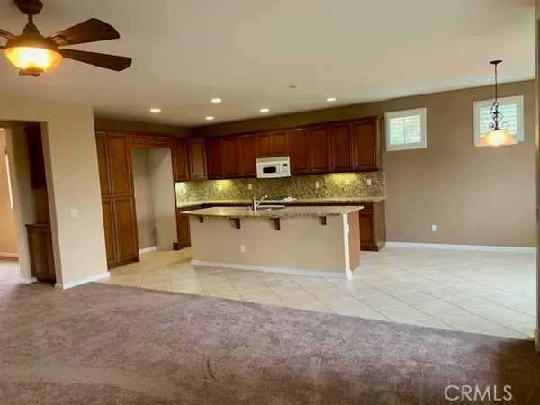 a kitchen with stainless steel appliances granite countertop a sink and a refrigerator