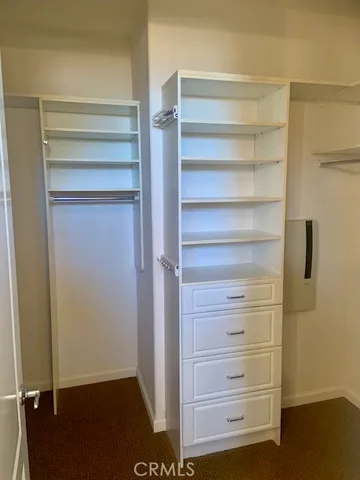 a view of walk in closet with empty racks
