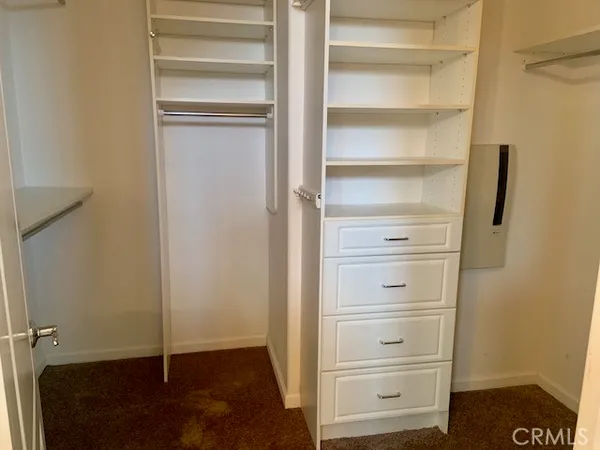 a view of walk in closet with empty racks