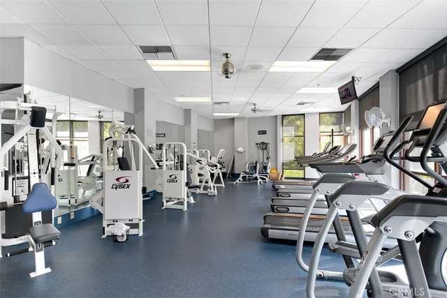 a gym room with lots of gym equipment