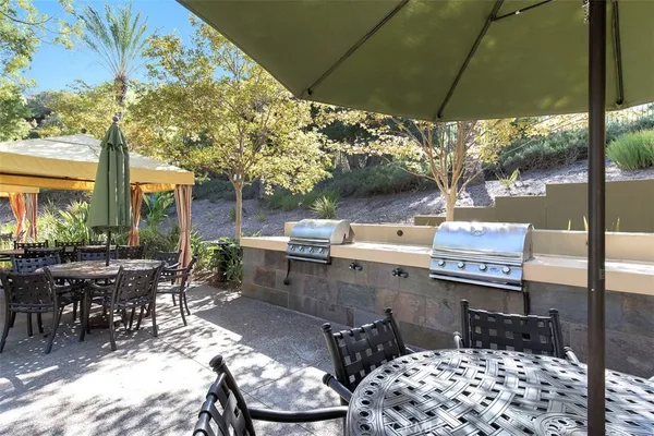 a view of a patio with table and chairs and potted plants
