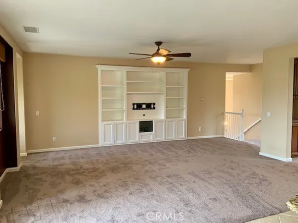 a view of a room with a ceiling fan