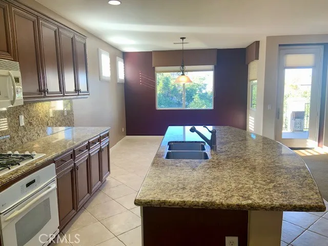 a kitchen with stainless steel appliances granite countertop a stove and a sink