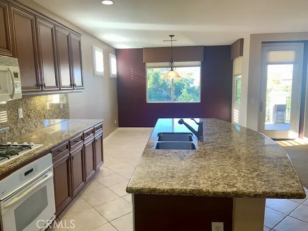 a kitchen with stainless steel appliances granite countertop a stove and a sink