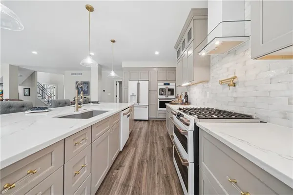 a large kitchen with a stove and cabinets