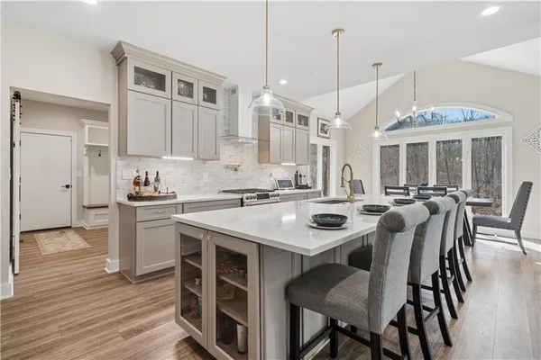 a kitchen with center island table and chairs