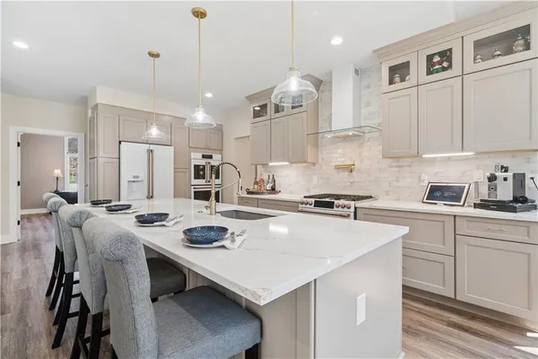 a kitchen that has a table and chairs in it