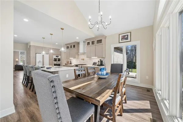 a view of a dining room with furniture and chandelier