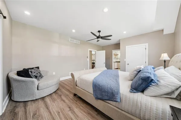 a spacious bedroom with a bed and furniture