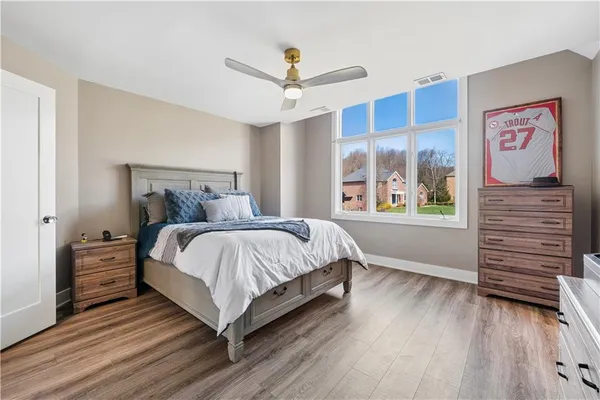 a bedroom with a bed and a large window