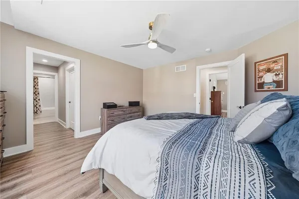 a bedroom with a bed and wooden floor