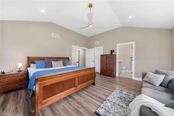 a bedroom with furniture and wooden floor