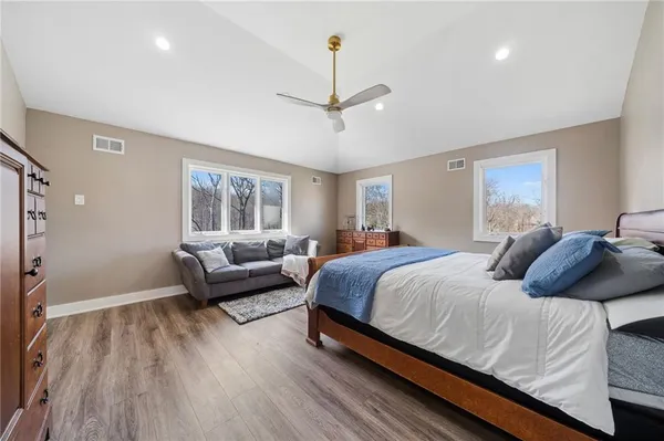 a bedroom with a bed and a couch