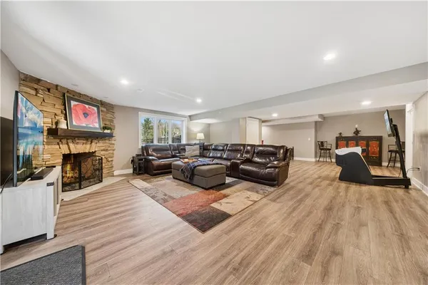 a living room with furniture kitchen view and a flat screen tv
