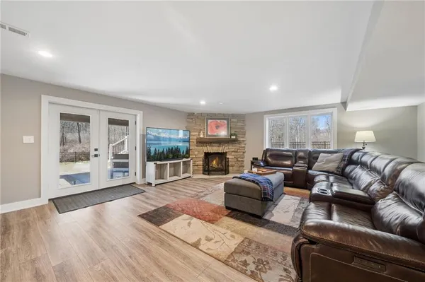 a living room with furniture window and wooden floor