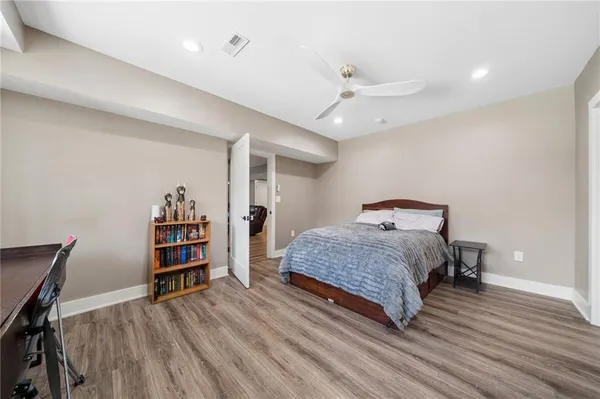 a bedroom with a bed and a book shelf